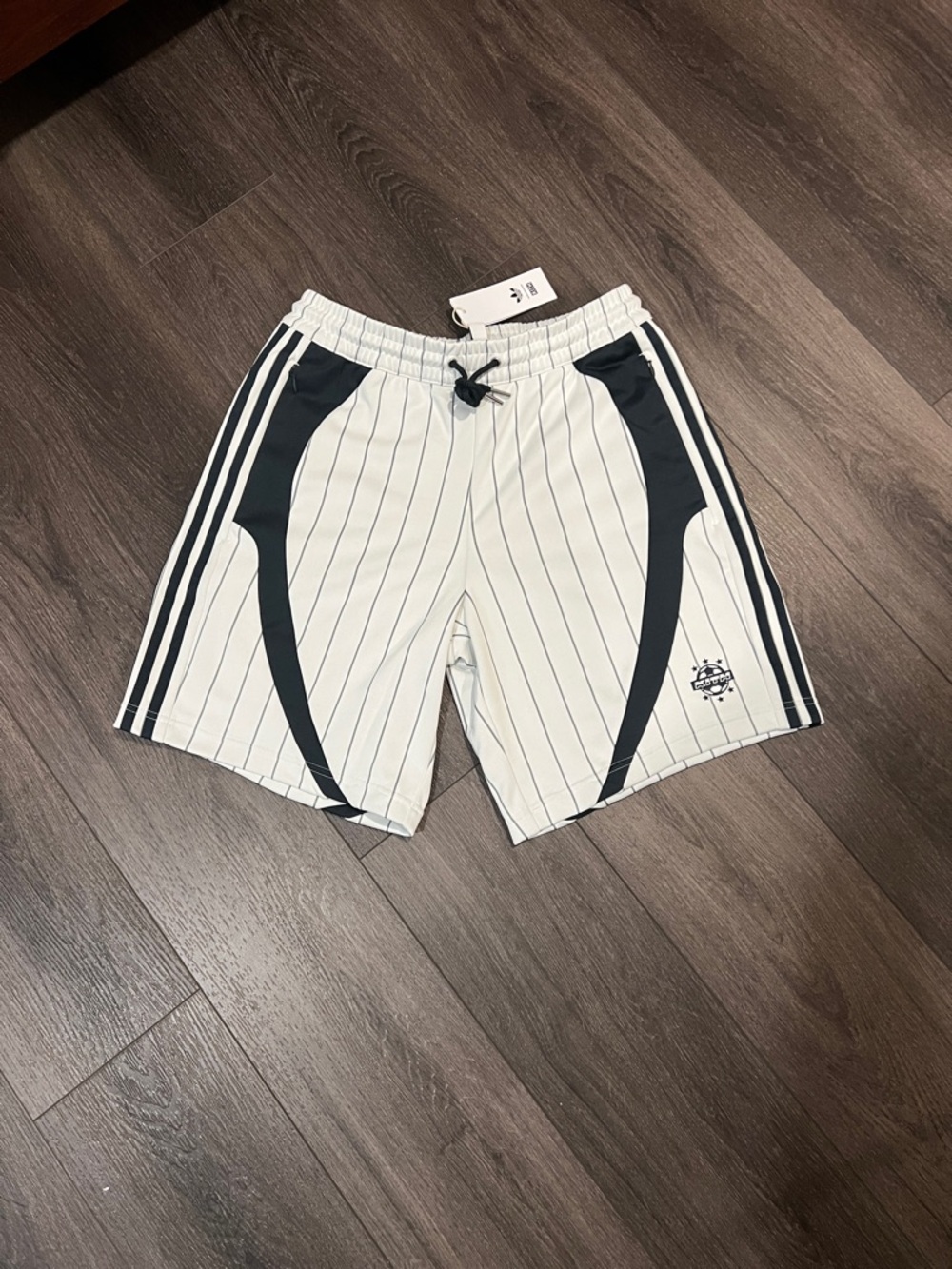 Men's White Pinstripe Athletic Shorts with Blue Accents.